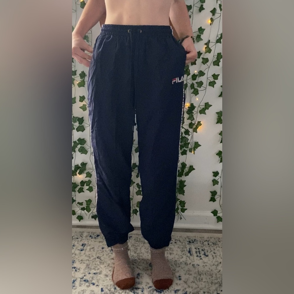 Navy blue FILA wind breaker pants.